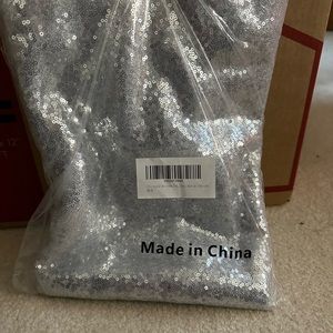 BRAND NEW IN PACKGE!! Sparkle silver table cover comes with 2 of them